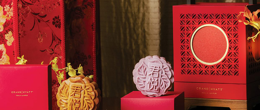 Elegant mooncakes in festive packaging.